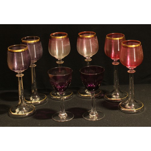 327 - A set of six tulip shaped hock wine glasses, the ribbed bowls in shades of pink and amethyst, slende... 