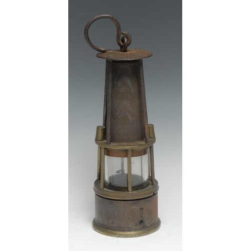 335 - Coal Mining - a 19th century steel and brass miner's lamp, oversailing circular cresting above a gau... 