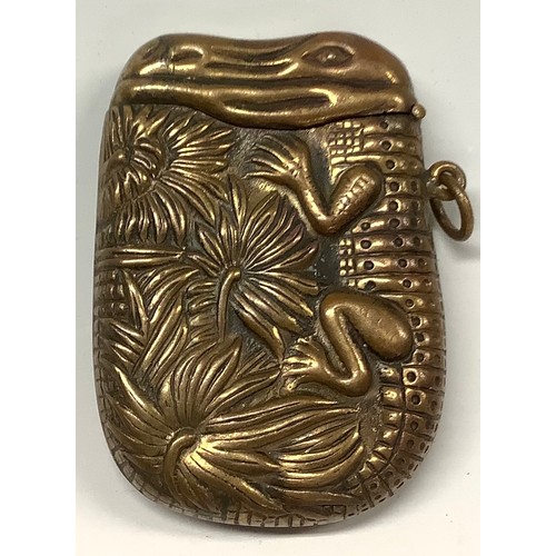 340 - A Japanese brass novelty vesta case, embossed with a crocodile, hinged cover, 6cm long, early 20th c... 