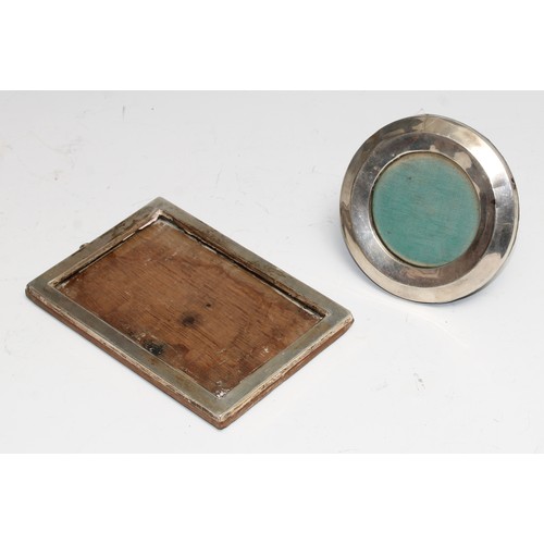 385 - An Edwardian silver circular easel photograph frame, Birmingham 1910; another, rectangular, A & J Zi... 