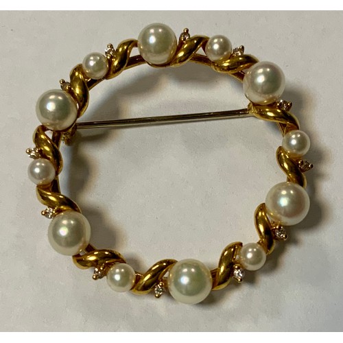 399 - A modern diamond and cultured pearl brooch, inset with twelve creamy white globular pearls and twelv... 