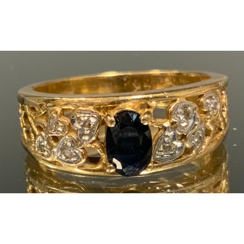 402 - A sapphire and diamond ring, raised quarter claw set deep blue oval sapphire approx 0.45ct above dia... 