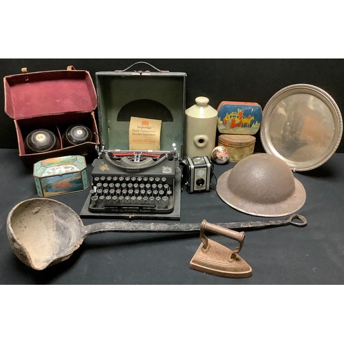 478 - A pair of crown green bowls, leather case; a military hard hat; an Imperial portable typewriter; a B... 