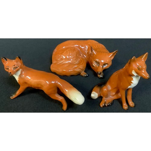 501 - A Beswick model of a recumbent fox; others, standing (3)