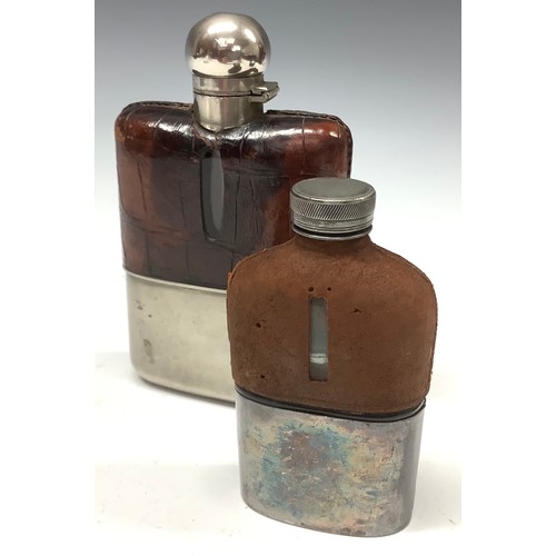 558 - A spirit flask with pigskin sleeve; another (2)