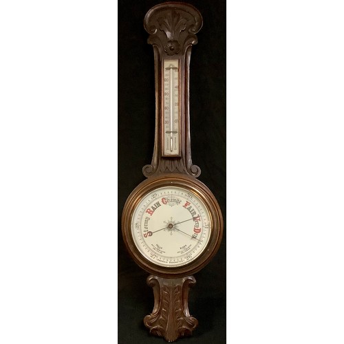 560 - An early 20th century oak aneroid wheel barometer, with thermometer, 88cm