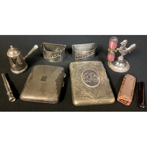 565 - Cigarette cases; cigarette holders; a cockerel egg timer; a coffee pot sifter; two napkin rings