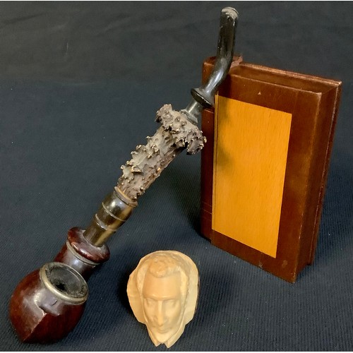 570 - Treen - a horn and briar pipe; a small box modelled as a book; a carved head (3)