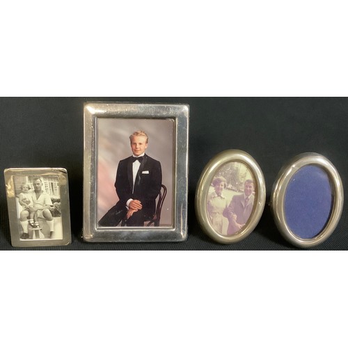 596 - An Edwardian silver miniature rectangular photograph frame, Chester 1905, 6.25cm x 4.5cm; a pair of ... 