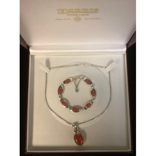 606 - A sterling silver carnelian pendant with silver necklace chain, marked 925; a similar sterling silve... 