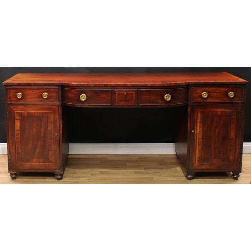 110 - A Regency mahogany bow-centre sideboard, crossbanded top above a central frieze drawer, each pedesta... 