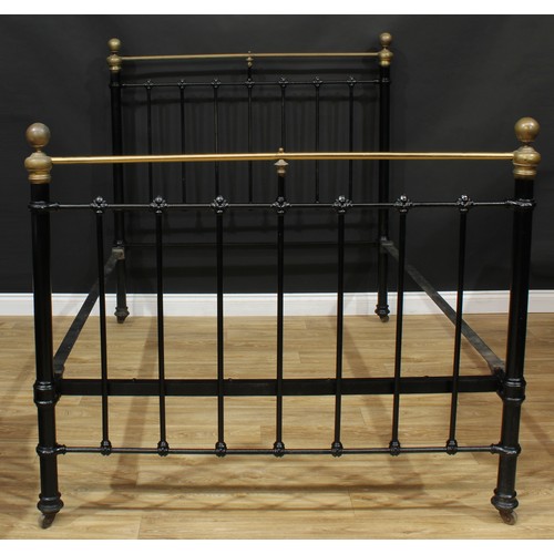 218 - A Victorian brass and painted bed frame, the headboard 145cm high, the interior 191cm x 137cm