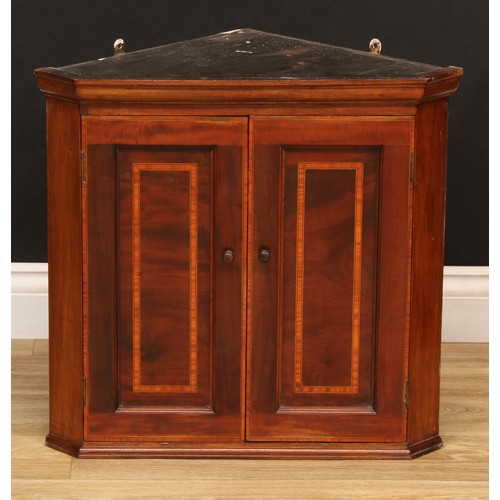 542 - A Sheraton inspired satinwood banded mahogany wall hanging splay front corner cupboard, of small pro... 