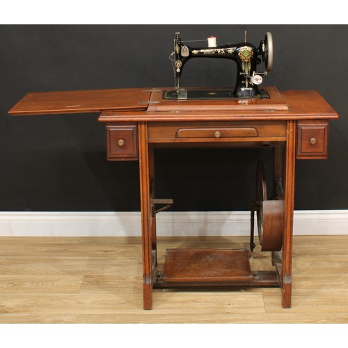 623 - A treadle sewing machine, 79cm high, 85cm wide, 45.5cm deep