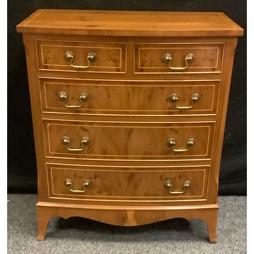 173 - A 20th century yew chest of drawers, bow-front rectangular top above two short and three long gradua... 
