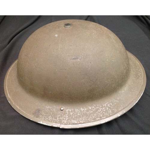 100 - WW2 British steel helmet. Original paint finish. Rim is maker marked and dated 