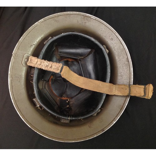 100 - WW2 British steel helmet. Original paint finish. Rim is maker marked and dated 