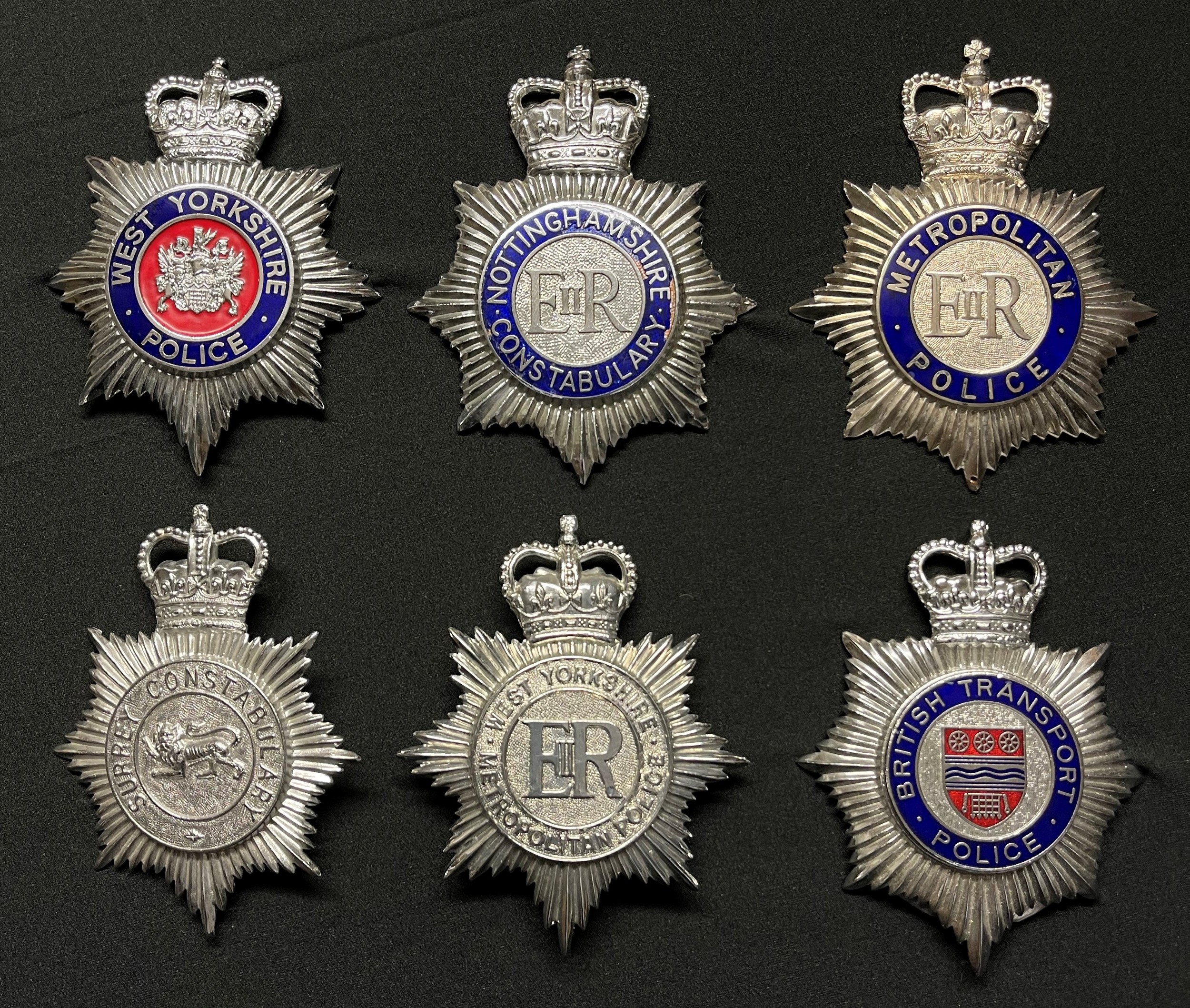 A collection of Police Helmet Plates: Queens Crown Enamelled...
