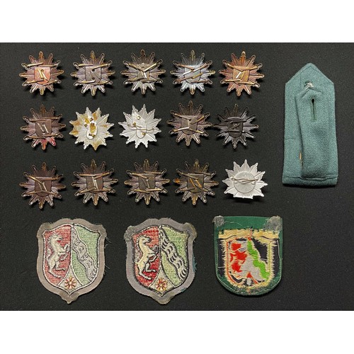 211 - A collection of 15 West German Police cap badges and cloth insignia.