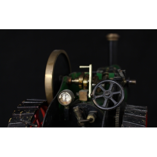 3034 - A live steam model traction engine, green livery, fitted with English style brass straked wheels, 3.... 