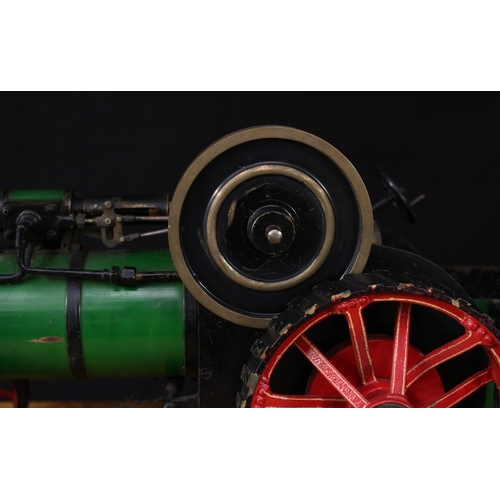 3034 - A live steam model traction engine, green livery, fitted with English style brass straked wheels, 3.... 