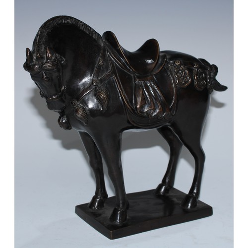 5129 - A Chinse dark-patinated equestrian bronze, of a Tang horse, cast in the archaic manner, square base,... 