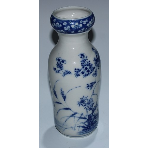 5173 - A Japanese porcelain inverted baluster vase, well-painted with a profusions of chrysanthemums and fl... 