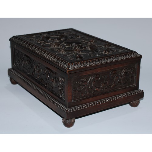 5217 - A near pair of Carolean Revival oak rectangular table-top caskets, the hinged covers boldly carved i... 