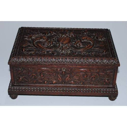 5217 - A near pair of Carolean Revival oak rectangular table-top caskets, the hinged covers boldly carved i... 