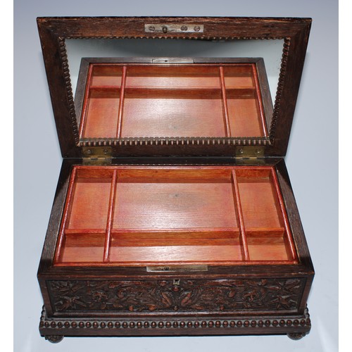 5217 - A near pair of Carolean Revival oak rectangular table-top caskets, the hinged covers boldly carved i... 