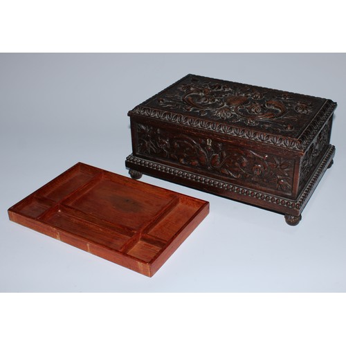 5217 - A near pair of Carolean Revival oak rectangular table-top caskets, the hinged covers boldly carved i... 