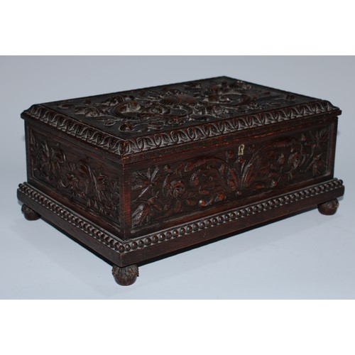 5217 - A near pair of Carolean Revival oak rectangular table-top caskets, the hinged covers boldly carved i... 