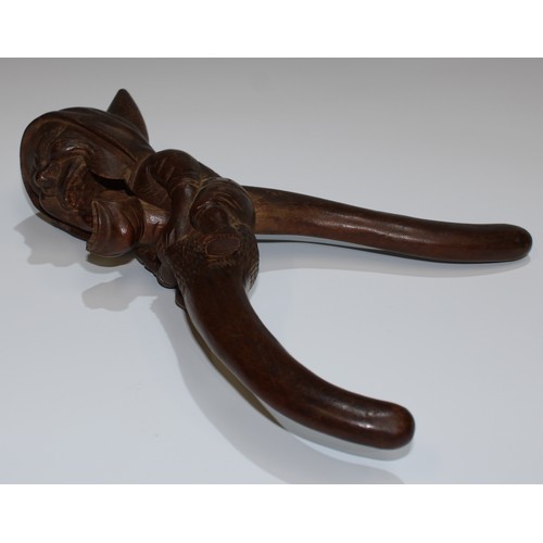 5078 - A Black Forest novelty lever-action nut cracker, carved as a gnome, full-length he sits astride, gri... 