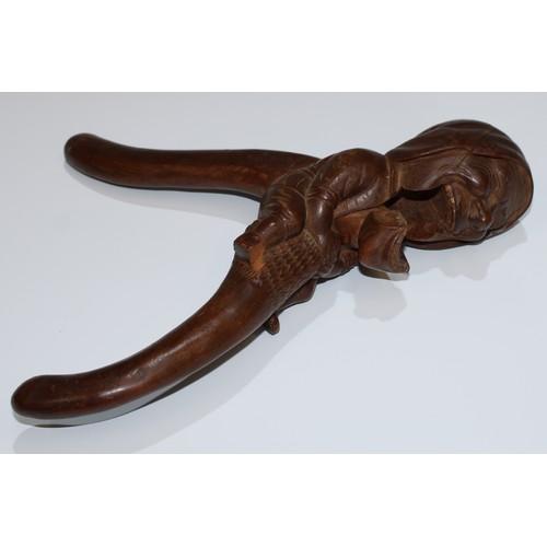 5078 - A Black Forest novelty lever-action nut cracker, carved as a gnome, full-length he sits astride, gri... 