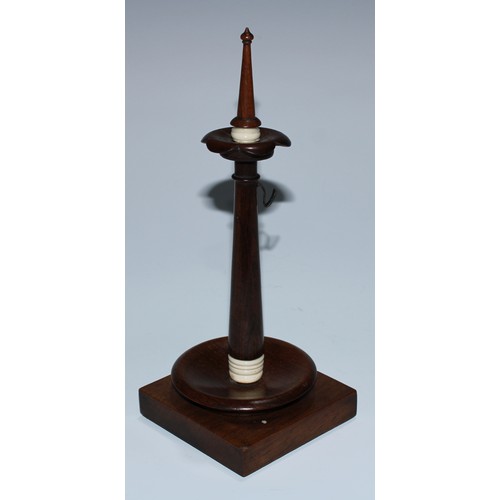 5065 - A 19th century rosewood pocket watch stand, the turned pillar with spire finial above a lotus boss, ... 