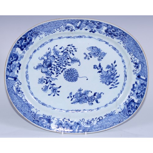 5108 - A Chinese Export porcelain oval serving platter, painted in underglaze blue with flowers, leafy foli... 