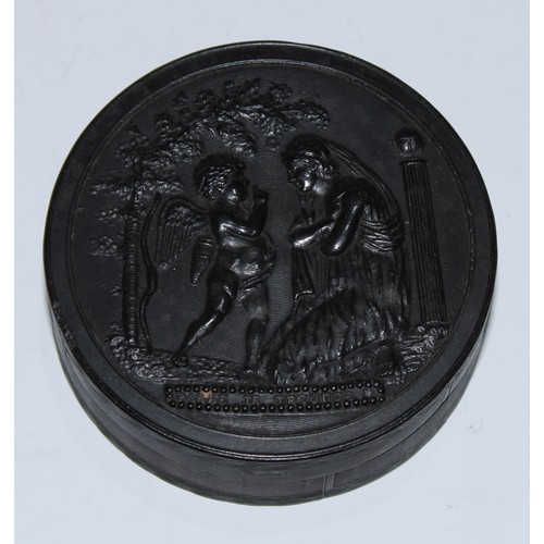 5063 - A 19th century pressed horn circular snuff box, the push-fitting cover in relief with Cupid and Psyc... 