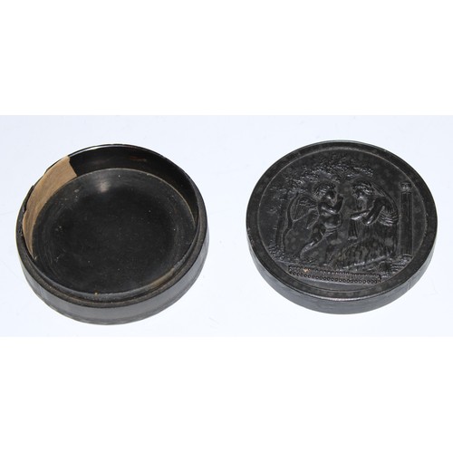 5063 - A 19th century pressed horn circular snuff box, the push-fitting cover in relief with Cupid and Psyc... 