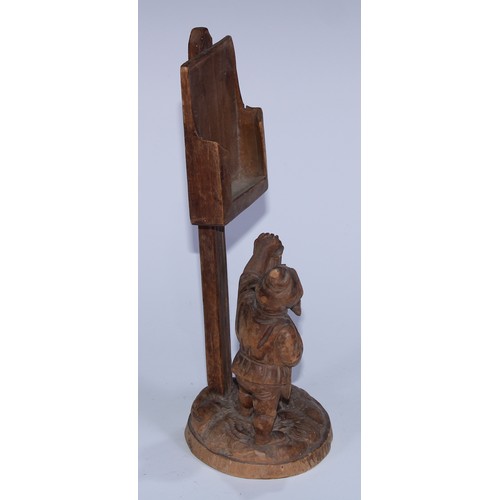 5077 - A Black Forest novelty country house menu stand, carved as a gnome holding a lantern beneath a sign ... 