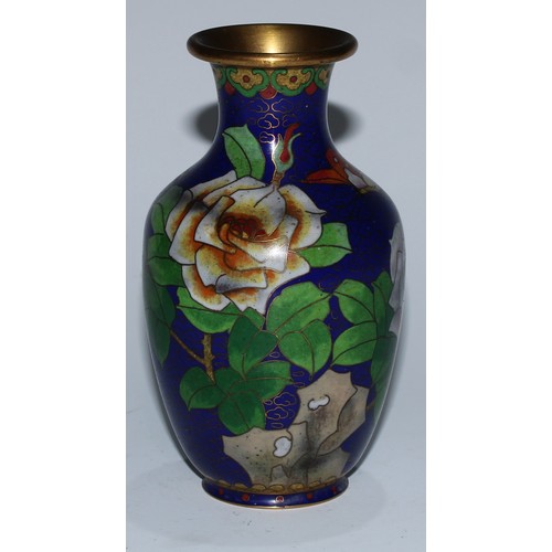 5107 - A Chinese cloisonne zun shaped vase, decorated in polychrome with a bird and blossoming prunus, on a... 