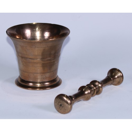 5087 - A bronze pestle and mortar, the flared cylindrical mortar ring-incised, 10.5cm high, 12.5cm diameter... 