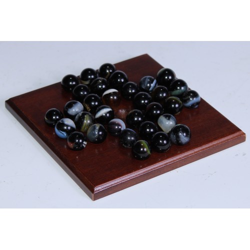 5200 - A mahogany solitaire board, marbles en suite, 13.5cm wide