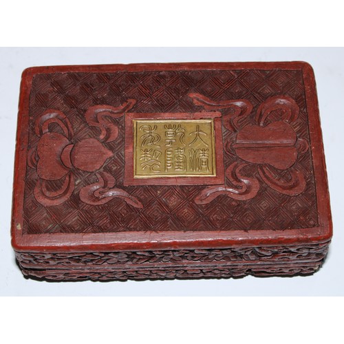 5103 - A Chinese cinnabar lacquer rounded rectangular box and cover, in relief with figures in a pagoda gar... 