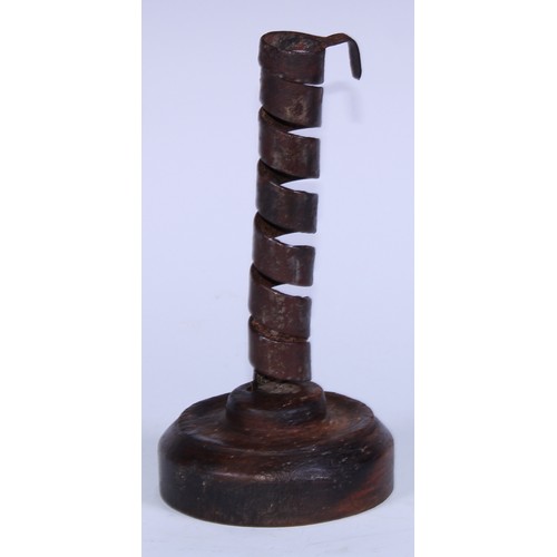 5074 - A 19th century wrought iron spiral candlestick, softwood base, 20cm high