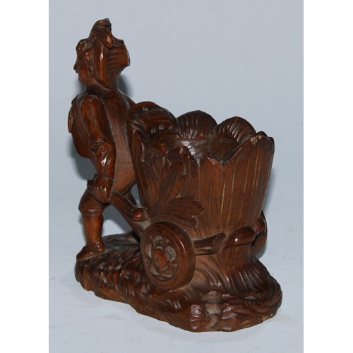 5079 - A Black Forest novelty table vesta, carved as a gardner drawing a barrow, 14cm high, c.1900