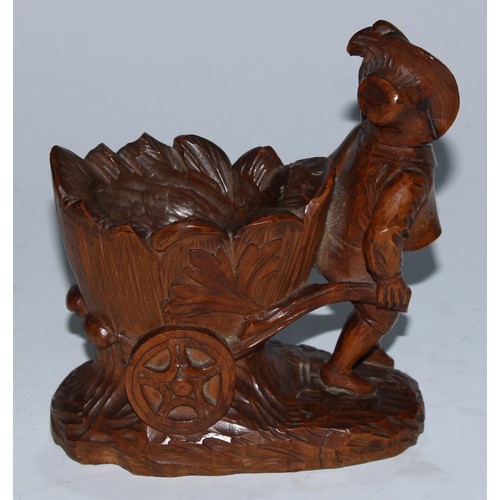 5079 - A Black Forest novelty table vesta, carved as a gardner drawing a barrow, 14cm high, c.1900