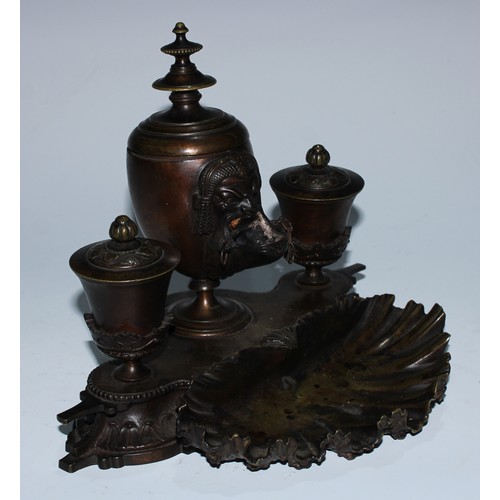 5059 - A 19th century patinated bronze inkstand, central ovoid lamp cast in the Grand Tour taste with a mas... 