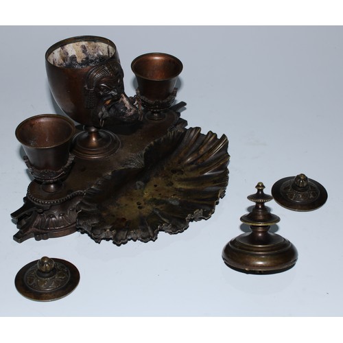 5059 - A 19th century patinated bronze inkstand, central ovoid lamp cast in the Grand Tour taste with a mas... 