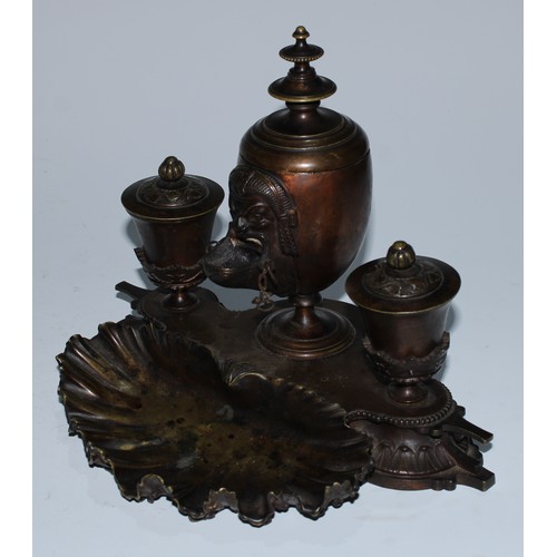 5059 - A 19th century patinated bronze inkstand, central ovoid lamp cast in the Grand Tour taste with a mas... 