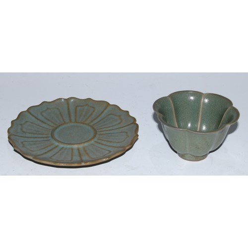 5100 - A Chinese celadon lotus wine cup and stand, the saucer 14cm diam